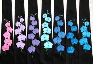 Seven black ties painted with pink, purple and blue orchids on them.